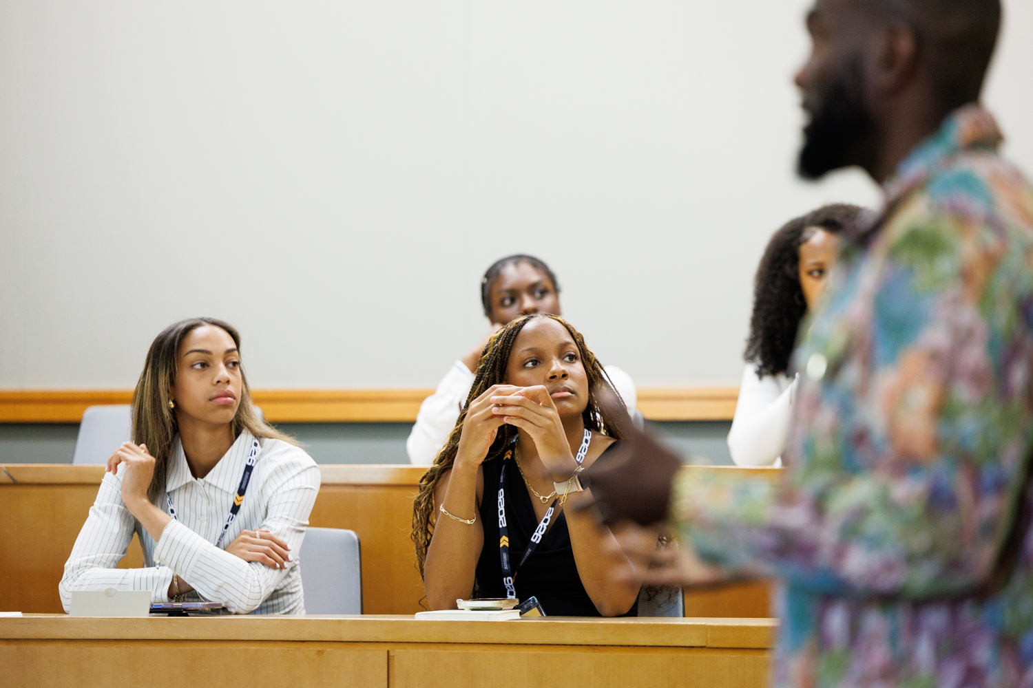 Two student-athletes attentively listening during a session